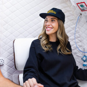 A female patient relaxes in SUMA Life House's comfortable hyperbaric chamber for 60 minutes of hyperbaric chamber treatment in Greenwich, CT.